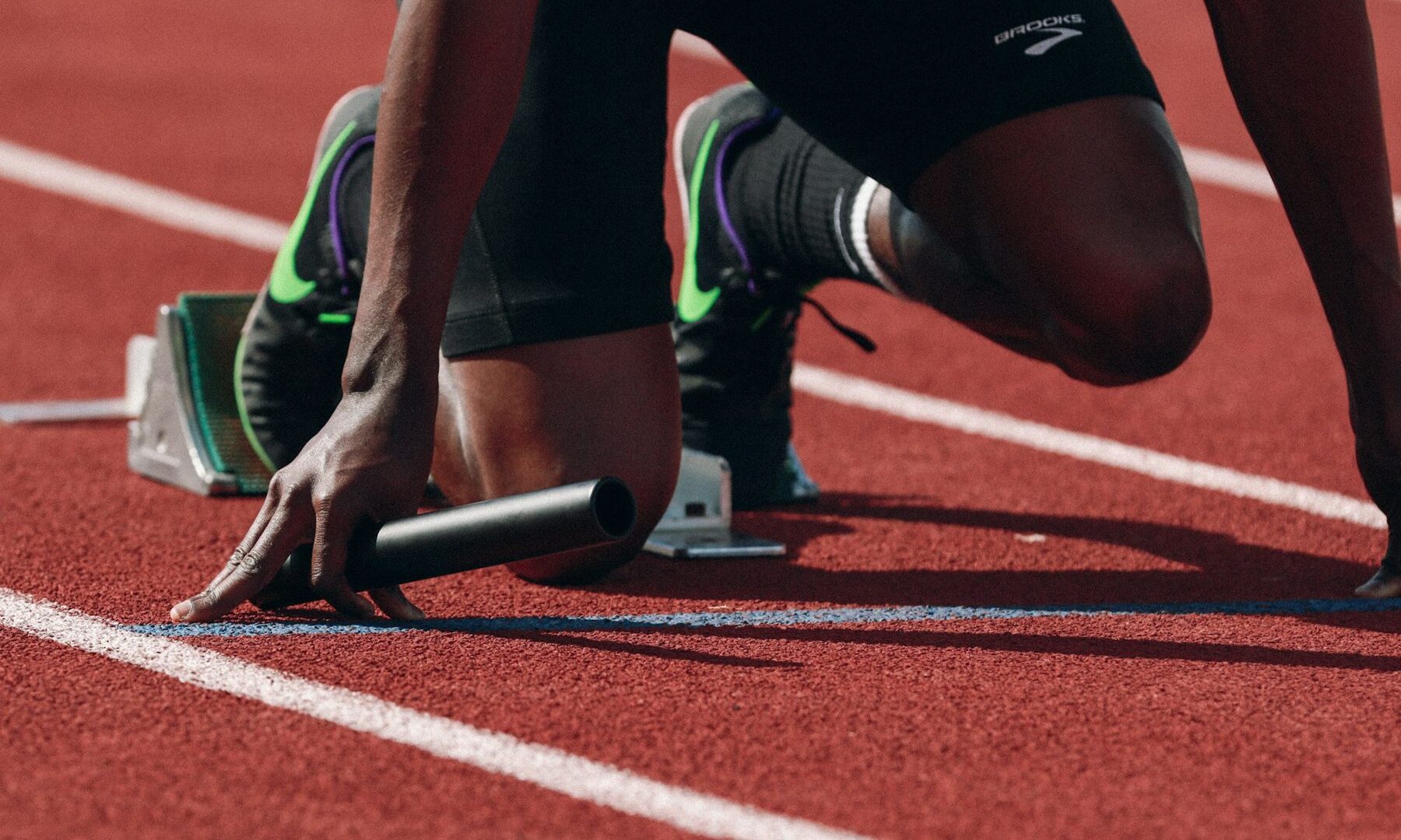 Sprinter in de startblokken op de atletiekbaan